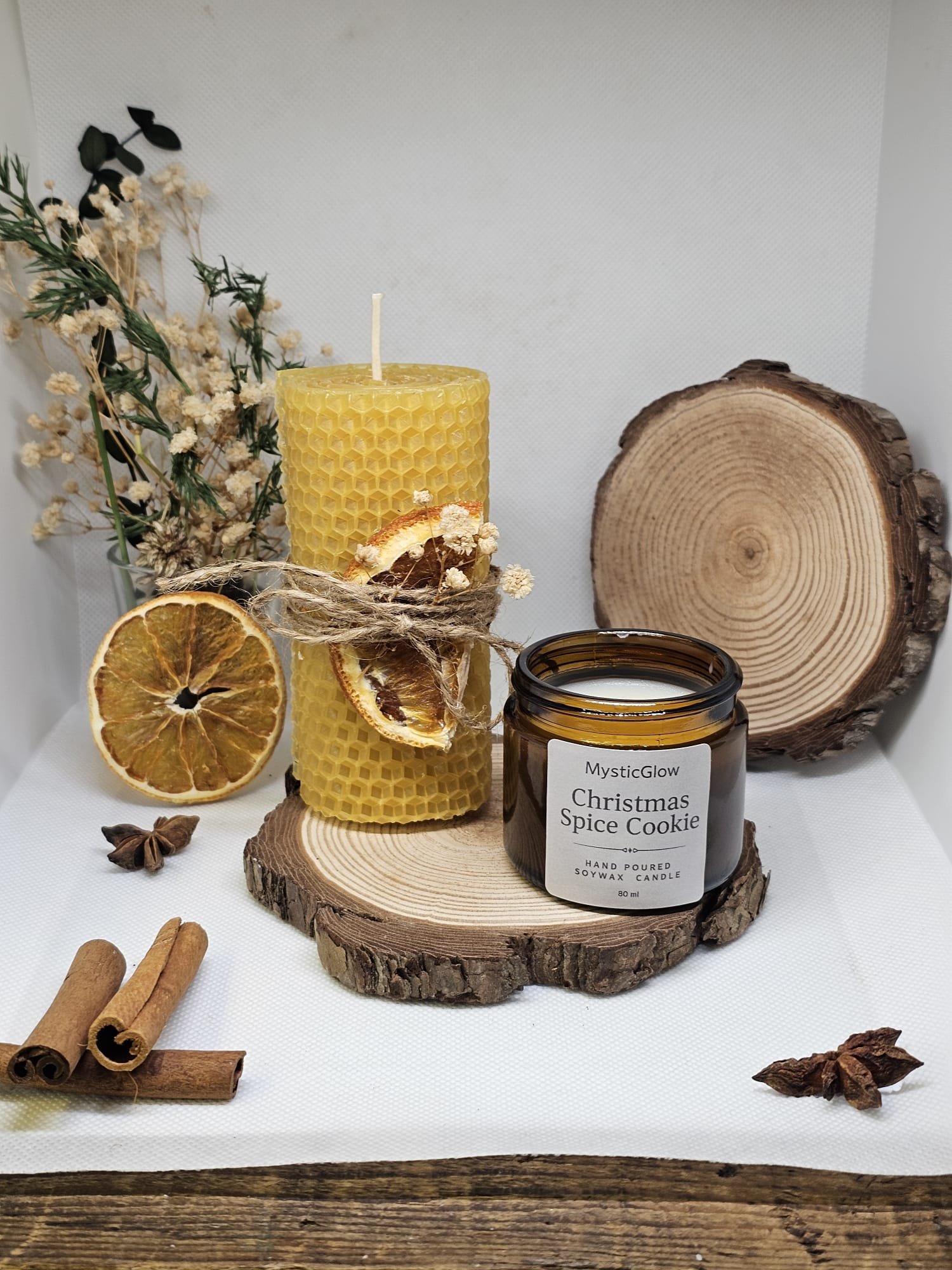 MysticGlow Christmas candle gift set with beeswax pillar and Christmas Spice Cookie soy candle on rustic wooden slices
