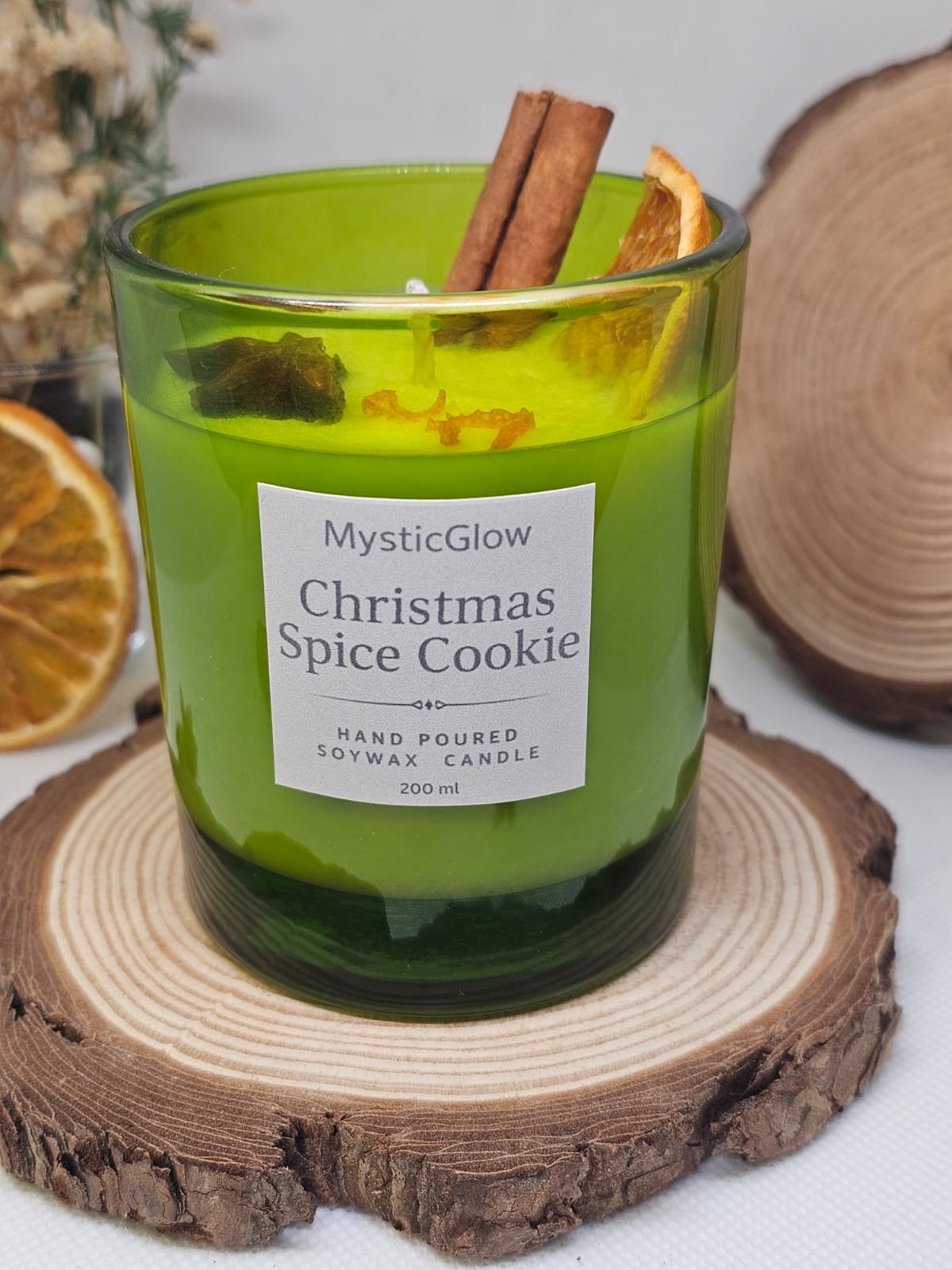 Close-up of MysticGlow Christmas Spice Cookie soy candle showing label and natural spice toppings