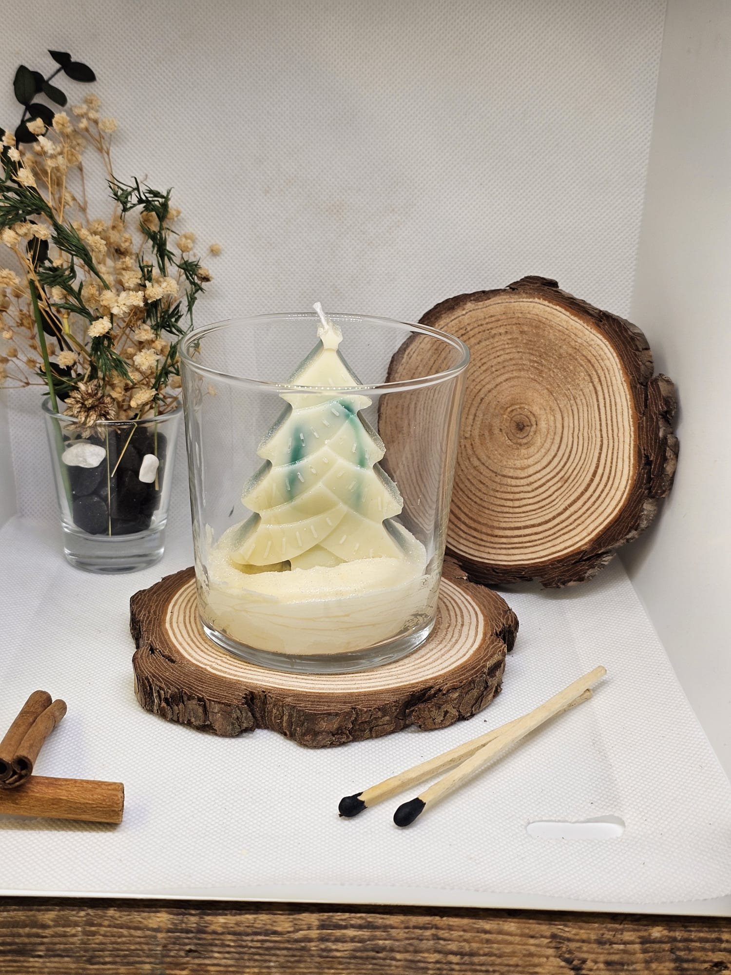 Handmade Christmas tree candle in clear glass with festive styling
