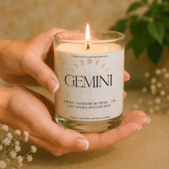 Handmade Gemini zodiac soy candle held in hands