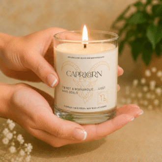 Handmade Capricorn zodiac soy candle held in hands