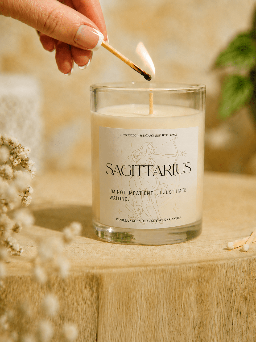 Sagittarius zodiac candle being lit by hand by MysticGlow