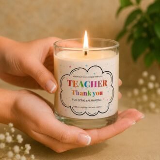 MysticGlow vanilla scented soy wax teacher thank you candle with a colourful appreciation label, held gently in hands with a glowing flame, perfect as an end of term teacher gift.